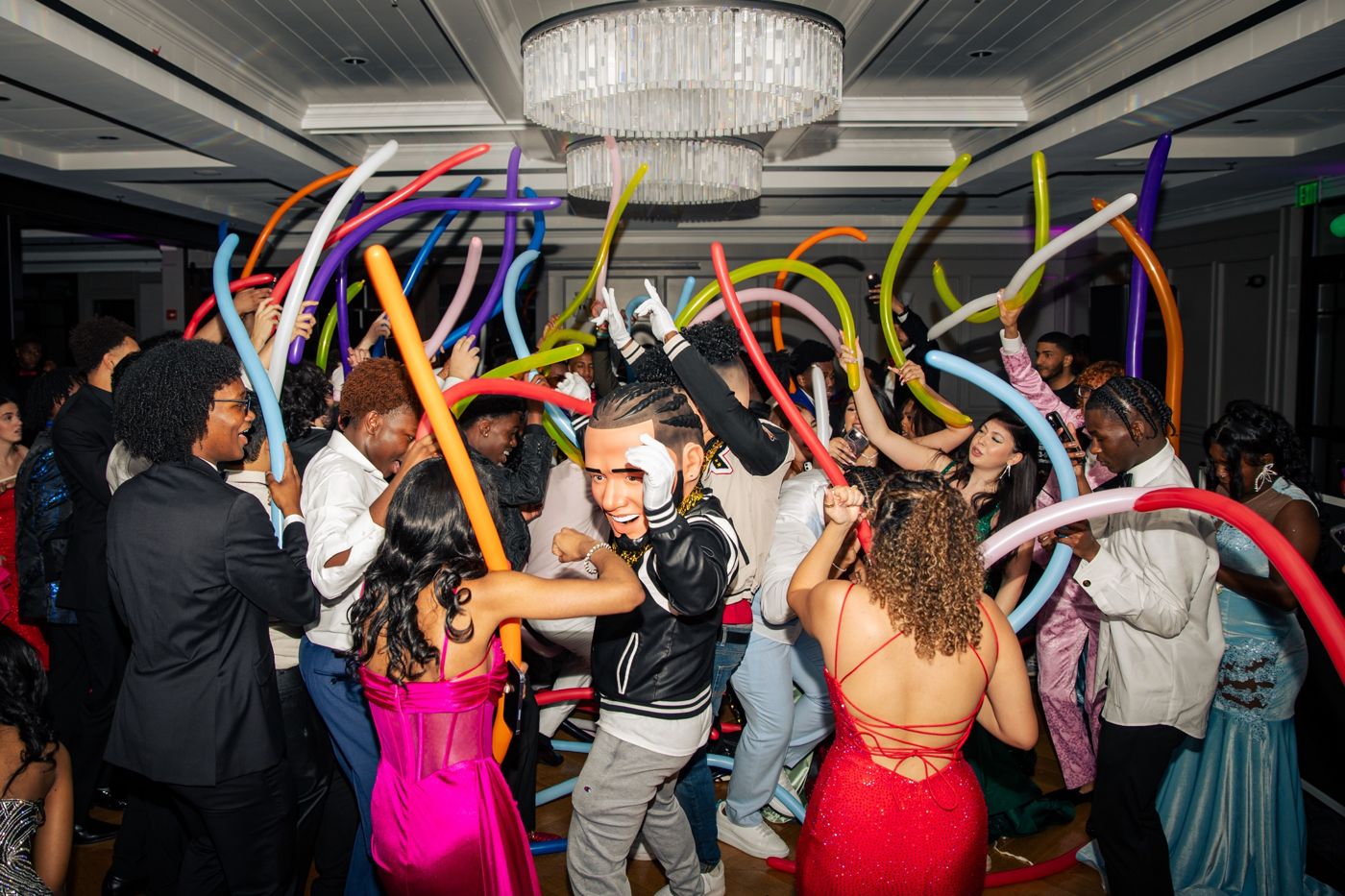 Guests dancing with colorful balloons on the dance floor